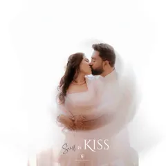 An artistic and dreamy shot of an engagement kiss, created with a slow shutter speed for a beautiful swirl effect. This technique adds a touch of magic to the moment.