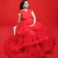 A simple, solid red background makes the texture of this ruffled gown pop. This is a great example of how we can create a high impact look with just color and light.