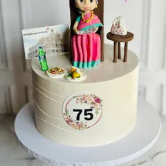 A custom edible cake for a Grandma’s 75th birthday. The handcrafted figurine captures her enjoying her favorite things, making it a truly personal and heartfelt tribute.