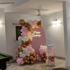 A wider view of the pink-themed birthday setup, showing how it can be placed in a living room or party space.