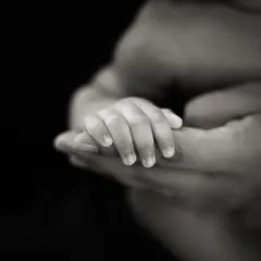 A different angle of the baby-holding-finger shot, this time in black and white against a dark background for a more dramatic effect.