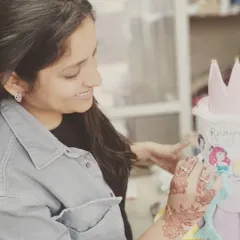 A candid shot of me adding the final details to a beautiful princess theme cake. I truly love what I do.