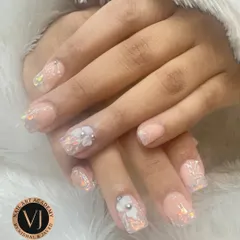 This design combines a subtle nude base with delicate 3D floral accents and iridescent flakes, a technique we teach for creating elegant, dimensional looks.