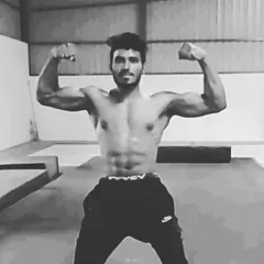 This is the result of discipline. A well-defined physique with visible abs and strong biceps, achieved through a targeted muscle gain and fat loss program.