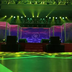 The high-tech stage setup for the sangeet, featuring large LED panels for custom graphics and professional stage lighting to create a concert-like experience for the performances.