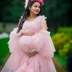 A close-up portrait showcasing the intricate details of this pink ruffled gown and the radiant glow of the mom-to-be. Professional makeup is included to make you feel your best.