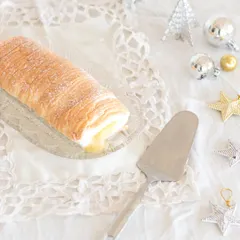 I love bringing treats from faraway places to you. This is a Brazo de Mercedes from the Philippines, a fluffy meringue roll with a sweet and tangy custard filling. It's luxuriously addictive!