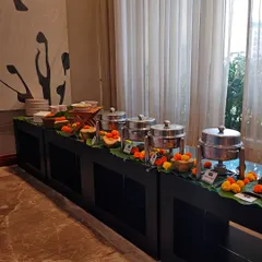 When I cater your house party, I bring the whole vibe. This buffet setup shows how I blend professional service with a warm, festive touch using banana leaves and marigolds, making your event feel special and personal.