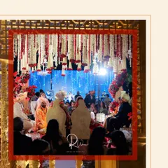 A shot from within the mandap during the ceremony, showing the couple surrounded by family under the breathtaking floral installation.