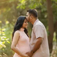 A tender kiss on the forehead is a classic for a reason. It's a simple, beautiful gesture of love, made even more magical by the soft outdoor light.