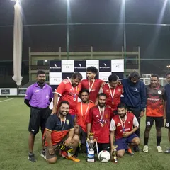 The runners-up team from the corporate tournament posing with their medals and trophy, celebrating a hard-fought competition.