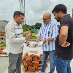 For new constructions, I work directly on-site with the builders and architects, reviewing plans to ensure the structure is aligned with Vastu principles from the very beginning. Here, I am discussing the layout and elemental balance for a new building to prevent future Vastu doshas and ensure a positive energy flow.