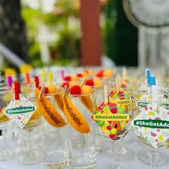 Fun and quirky details are my specialty. These custom glass tags with the hashtag #SheGotAdded add a playful element to the drinks, ensuring every detail aligns with your event's theme and story.