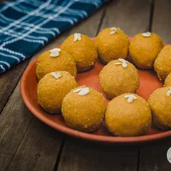 Our classic Besan Laddoo, made from roasted gram flour, ghee, and sugar. Topped with almonds, it's a simple, timeless sweet that everyone loves.