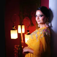 A close-up of our bright yellow Haldi outfit, showing the colorful embroidery and the perfect jewelry to match.