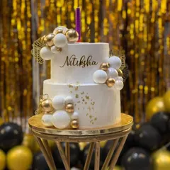 It's always a joy to see my cakes as the centerpiece of a celebration. This client photo shows the two-tier white and gold cake in its beautiful party setting.
