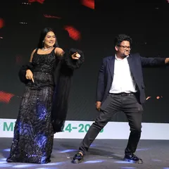 Even the hosts need to have some fun! Sharing a dance move on stage during the Housiey Annual Meet. It's all about keeping the mood light and celebratory.