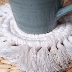 A close-up showing how the coaster protects your table while adding a touch of boho style.