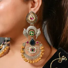 A close-up shot of an ornate, dual-tone chandbali earring with intricate bird motifs and colorful stones. This highlights my skill in capturing detailed craftsmanship for product catalogs.