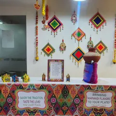 To complement a Marwadi-themed office celebration, I styled this food counter to perfection. The decor includes a colorful patterned table skirt, traditional Rajasthani wall hangings, and a decorated matka, creating an authentic and immersive experience for the employees.