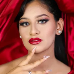A close-up that focuses on the perfect red lip and sharp winged eyeliner, key skills for any professional makeup artist.
