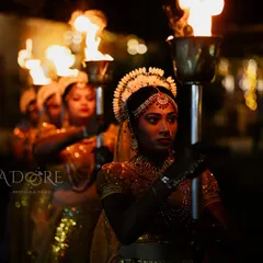A dramatic and beautiful welcome for the couple. Performers in traditional attire hold fire torches, lighting the way and adding a touch of grandeur to the wedding procession.