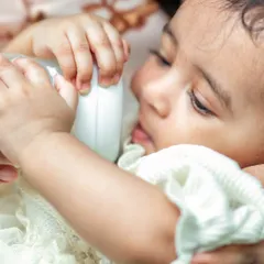 A close-up of a newborn feeding, a simple yet profoundly intimate moment. I focus on capturing these real, unposed details of early parenthood.