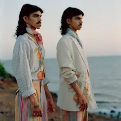 A closer view of the models against the sea. The golden hour light was a crucial element of my creative direction, adding warmth and a nostalgic quality to the images.