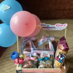 A perfect hamper for a gender reveal party. I use pink and blue themes with balloons and fun stickers to build excitement, packing the crate with delicious cookies and snacks for everyone to enjoy during the celebration.