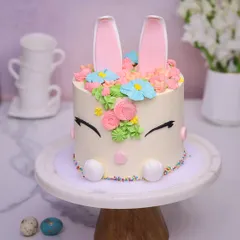Our Easter Bunny Cake is a springtime delight, with sleepy eyes, colorful sprinkles, and a crown of buttercream flowers.
