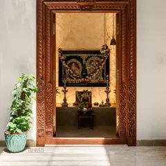 For the Prakash Reddy residence, we designed this traditional pooja room with an intricately carved teak wood door frame. The warm lighting and classic design create a space that feels timeless and sacred.