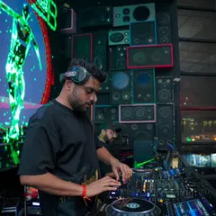 Focused on the mix, with abstract visuals from my VDJ set creating an immersive backdrop. The combination of audio and visuals is key to my club performances.