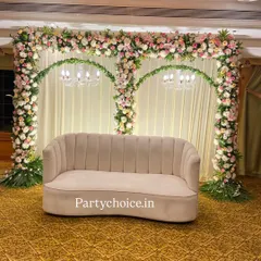 For this indoor engagement, we created a backdrop of double floral arches made from pink and white roses. The arches are accented with chandeliers, framing the couple's sofa beautifully.