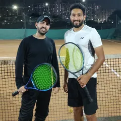 Another shot of our head coach with a student from our adult program. We provide a supportive environment for adults to learn, improve their fitness, and enjoy the game of tennis.