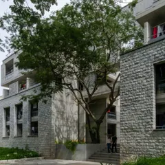 The interplay of exposed concrete and stone masonry at the new IIM hostel. This material strategy was a deliberate choice to connect with the older buildings on campus while using contemporary construction techniques.
