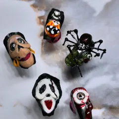 A flat lay of my spooky, hand-sculpted Halloween competition nails. Each nail is a miniature work of art, from the bloody eyeball to the creepy-crawly spider.