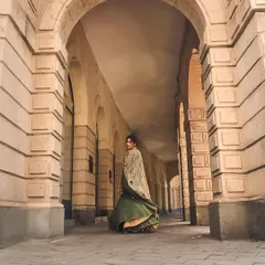 Another perspective on this stunning fusion lehenga, capturing the grandeur of the outfit and its surroundings. The way the jacket drapes creates a regal yet modern feel.