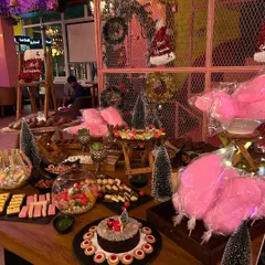 A spectacular 'Candy Land' grazing table I created for a kids' birthday party. It was filled with cakes, candies, cotton candy, and chocolates, making it a dream come true for any child.