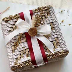 We design wedding invitations that set the tone for your entire celebration. This handcrafted woven box, finished with a custom wax seal, moves beyond a simple card to become a beautiful keepsake and the first taste of your wedding's aesthetic.