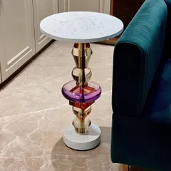 Meet "Floss," our handmade accent table inspired by the Memphis design movement. It features a unique leg made of stacked acrylic and metal forms, topped with a minimal white terrazzo surface, creating a bold pop of color and shape.