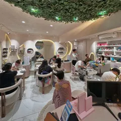 A snapshot of a busy day at Bellissimo. Our studio is filled with clients enjoying manicures and pedicures, showcasing the lively and popular atmosphere we've cultivated.