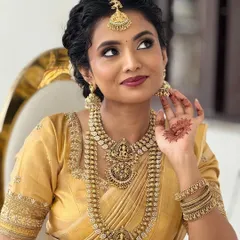 A beautiful candid shot of my bride Anju, showcasing her traditional South Indian bridal look with intricate temple jewelry.