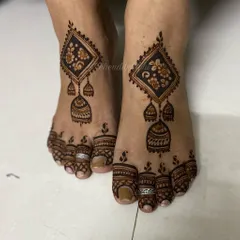 A unique and modern foot design featuring a geometric diamond shape with hanging 'jhumka' or earring motifs.