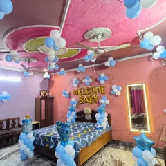 A wide-angle view of the blue and white 'Welcome Baby' room decoration, showing how the entire room is filled with festive balloons.