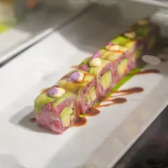A colourful and creative sushi roll, featuring beetroot-infused rice and avocado. This is another example of our innovative approach to classic dishes.