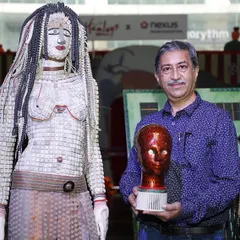 Here I am with one of my wearable art sculptures, crafted entirely from discarded keyboard keys and electronic components. This piece explores the relationship between the human form and the technology that surrounds us, turning e-waste into a statement on sustainable fashion.