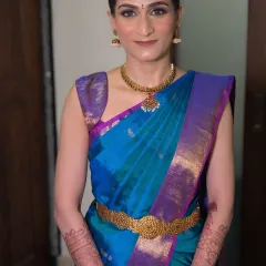 My modern Tamil bride Shriya, looking absolutely chic. I created a natural, glowing makeup look and draped her beautiful blue pattu saree to perfection, ensuring she felt comfortable and radiant.