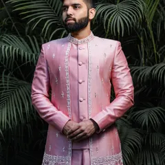 This client is the picture of modern elegance in a lustrous pink silk Indo-Western jacket. The ensemble features subtle, intricate embroidery along the placket and hem, offering a sophisticated and contemporary choice for a wedding guest.