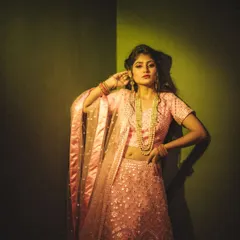 Playing with colored gels to create a specific mood. The sharp shadow and the green-yellow light give this fashion portrait an edgy, high-fashion feel, transforming the corner of a room into a studio set.