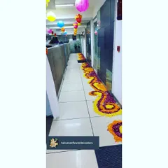 A detailed look at the winding floral rangoli path we created in the office corridor. Using fresh marigold and rose petals, this traditional floor art adds color and a festive feel throughout the office.